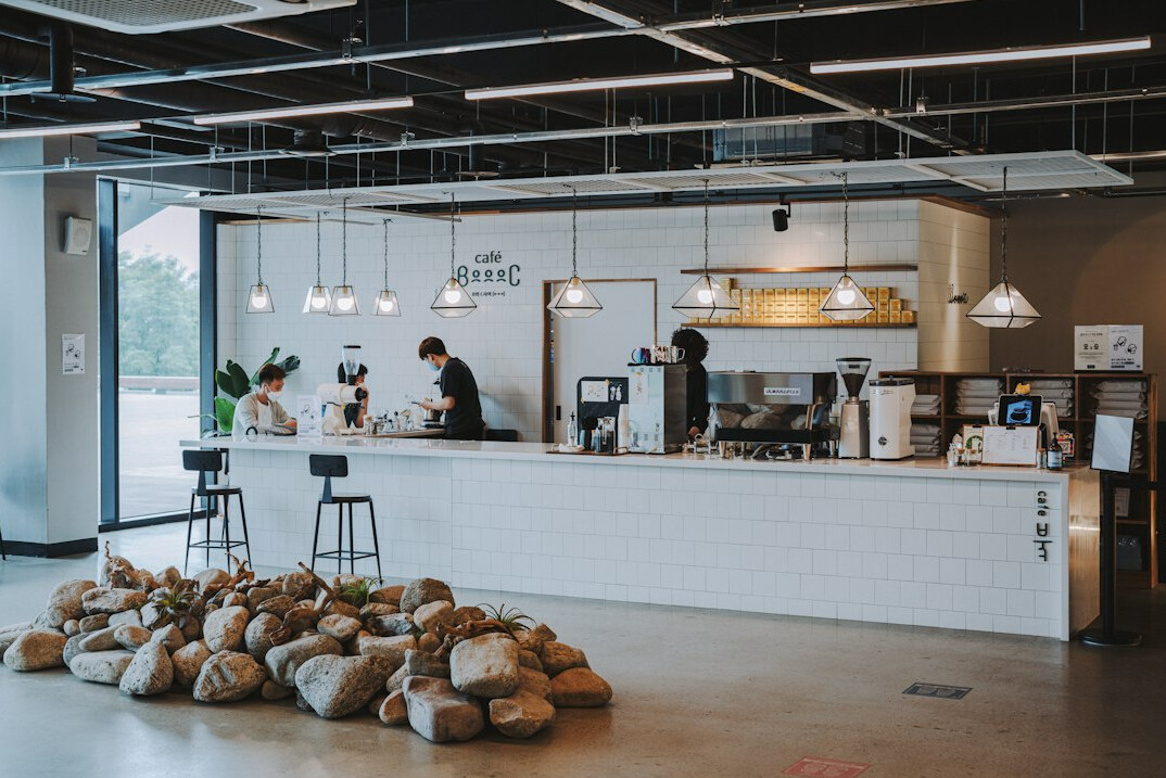 Colleagues collaborating with laptops in a modern coworking space